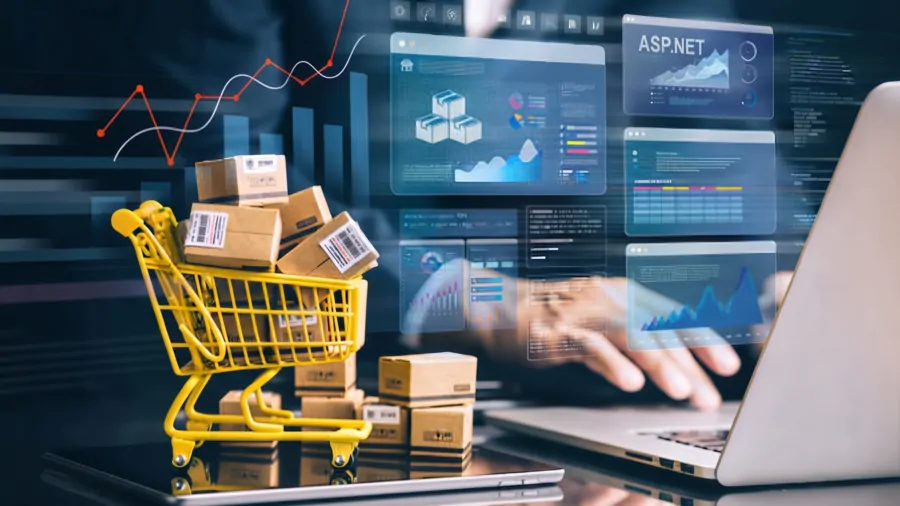 A shopping cart of boxed orders on a laptop, surrounded by floating B2B e-commerce dashboards and sales analytics charts