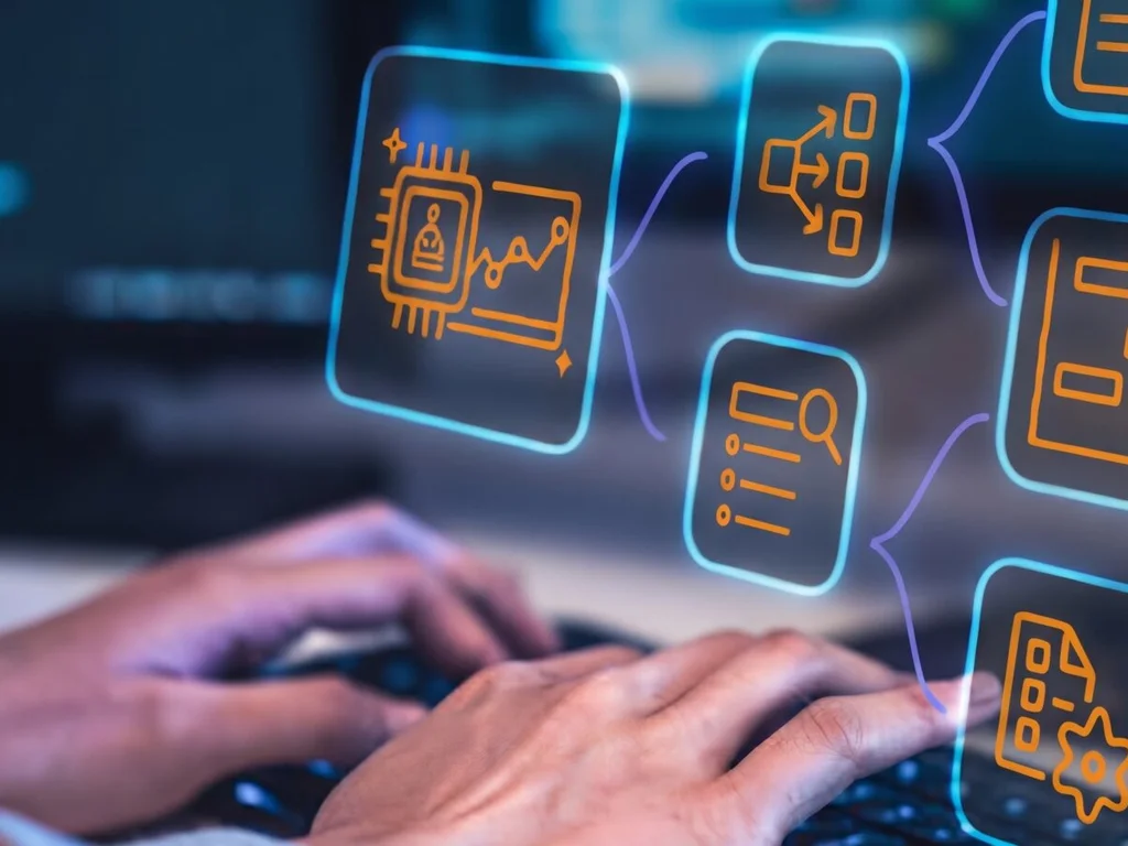 Hands on a keyboard with data and workflow icons floating above it