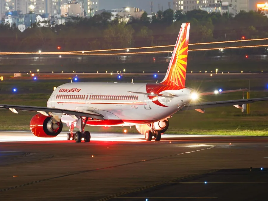 An aircraft on the apron at an international airport at night