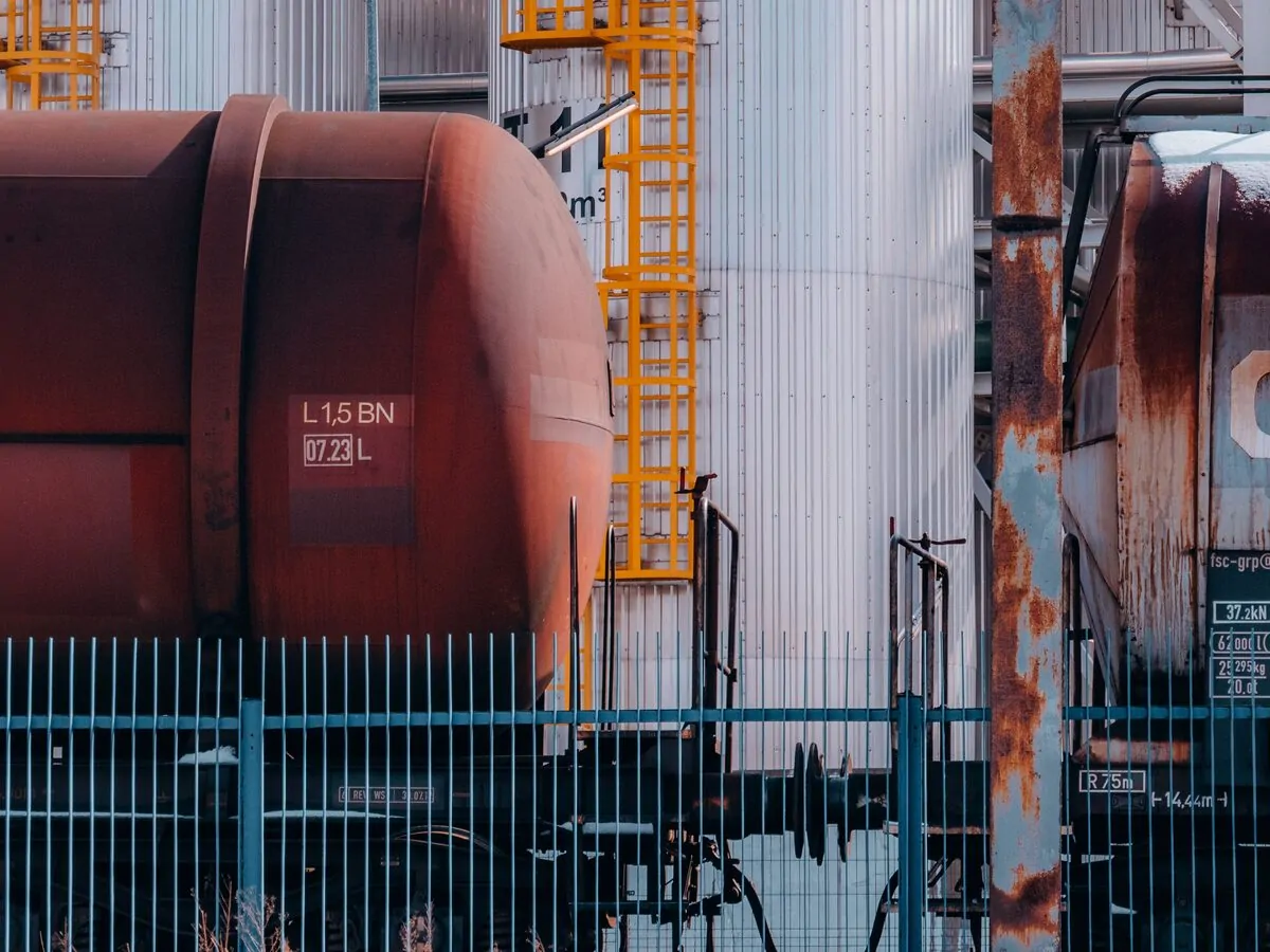 Rail tank wagons alongside bulk fuel storage tanks