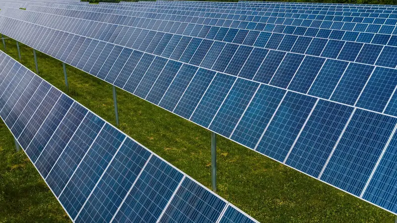 Rows of solar panels across a utility-scale photovoltaic array